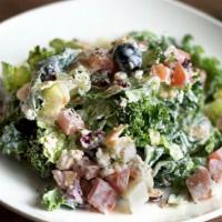 Farida Kale Salad  · Mixed fresh kale and romaine hearts, black olives, cranberries, toasted almonds, diced tomat...