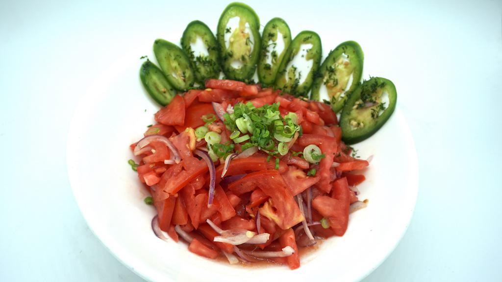 Achichuk Salad · Thinly sliced tomatoes, cucumber, red onions, mixed with freshly chopped dill.