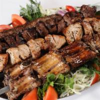 Beef Fillet Mignon Shashlyk · Large skewered kebab grilled on fruit seed wood charcoal served with organic home fries, mar...