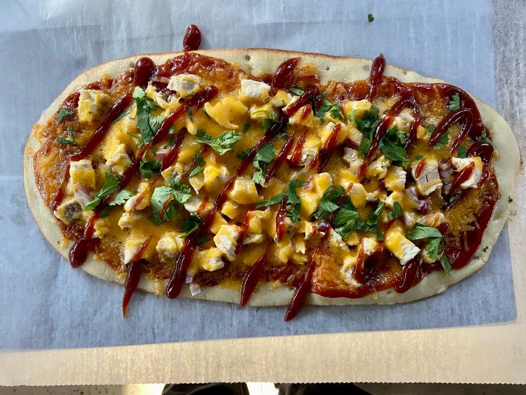 BBQ Chicken Flat Bread Pizza · House BBQ Sauce, Diced Chicken Breast, Red Onion, Cheddar cheese blend, Cilantro and spices on a 14x7 flat bread that makes 10-12 tavern style slices.