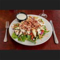 Bleu Bessy Salad · Romaine topped with chicken, bacon, artichoke hearts, red peppers, carrots, red onions and b...
