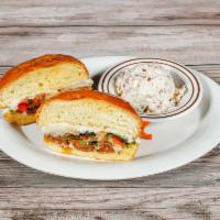 The Sausage Sandwich · Served with choice of grilled chicken or spicy smoked hotlink. Topped with sautéed onions, s...