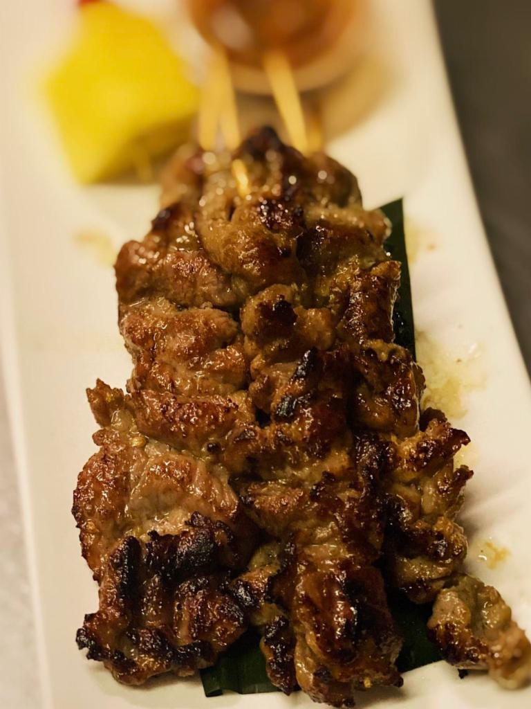 A11.Moo Ping · Pork skewers marinated in Thai herbs served with jeaw sauce. Extra dipping sauce will be an +$1