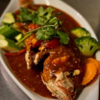 Pla rard prik · Whole red snapper in a sweet chili sauce served with a side of jasmine rice.