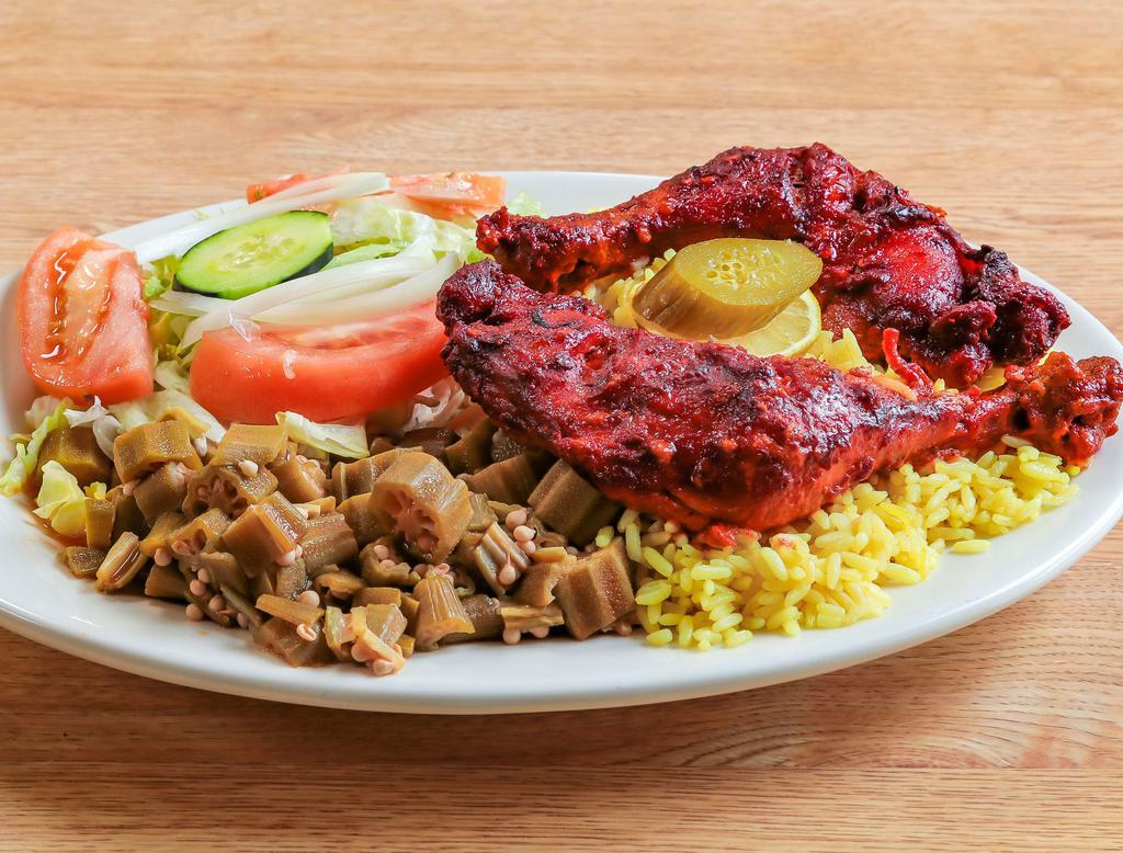 Chicken Curry · Cooked seasoned chicken parts, served with rice, vegetables, salad, homous and pita bread. 