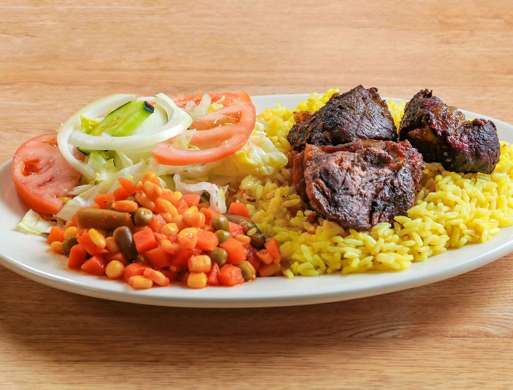 Lamb Stew and Rice · Cooked seasoned lamb parts, served with rice, vegetables, salad, homous and pita bread.