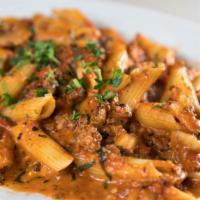 Penne Bolognese · Penne with meat sauce, mushrooms, herbs, and Parmesan.