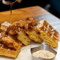 Chicken and Waffles · Crispy chicken tenders, sausage gravy, maple syrup 