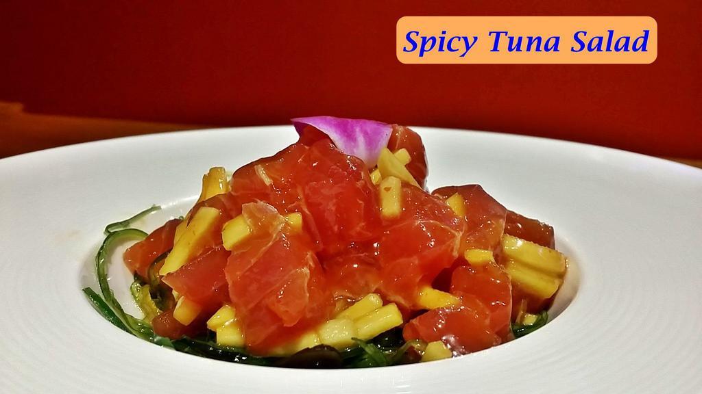 Spicy Tuna Salad · Tuna and mango mixed with sweet chili sauce, serves on seaweed salad. contains: sesame seed, sesame oil, soy.
