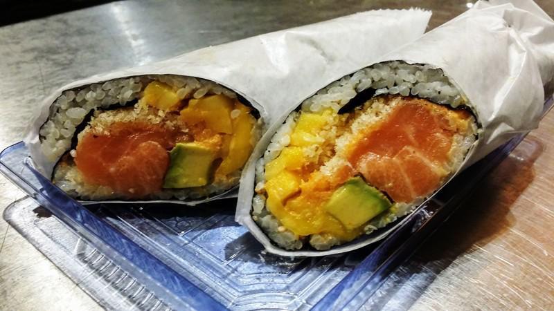 Salmon Monster Sushirrito · Salmon, avocado, mango, tempura flakes with spicy mayo and sweet chili sauce wrapped by seaweed, sushi rice and sesame seed. contains gluten, egg, sesame oil.
