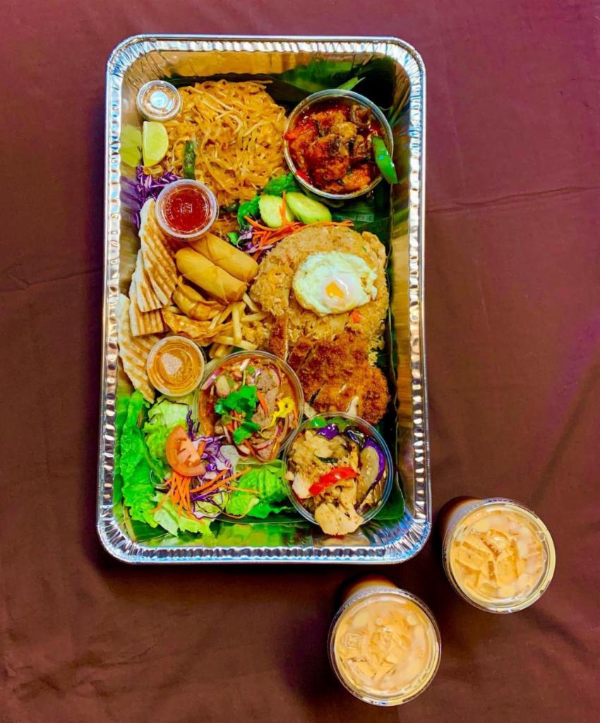 Thai Family Tray · Includes: Fried Rice Chicken and Fried Egg, Fried Chicken Cutlet, Pad Thai Chicken and Shrimp, Spicy Crispy Catfish, Beef Salad, Eggplant Chicken, Appetizer Assortment (roti, pot stickers, egg rolls, fries), 2 Thai Iced Teas. Serves 4-5 people
