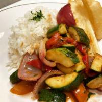 Veggie Saltado · Roasted peppers and zuchinni stir fried withe tomatoes, onion and soy saucell served over yu...