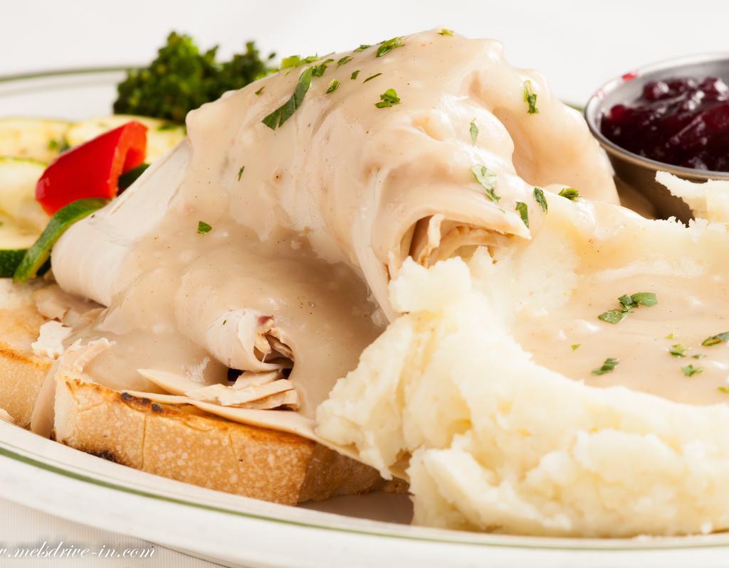 Mel's Famous Hot Turkey Sandwich · Fresh sliced roasted Turkey breast Served with homemade gravy, Mel's own lumpy mashed potatoes and veggies and cranberry sauce.