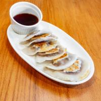 6 Pork and Cabbage Dumpling  · Our signature style pork with ginger, white onions and cabbage.