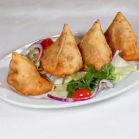 6. Samosa · Deep-fried pastry triangles stuffed with spiced potatoes and green peas. 2 pieces per order. 