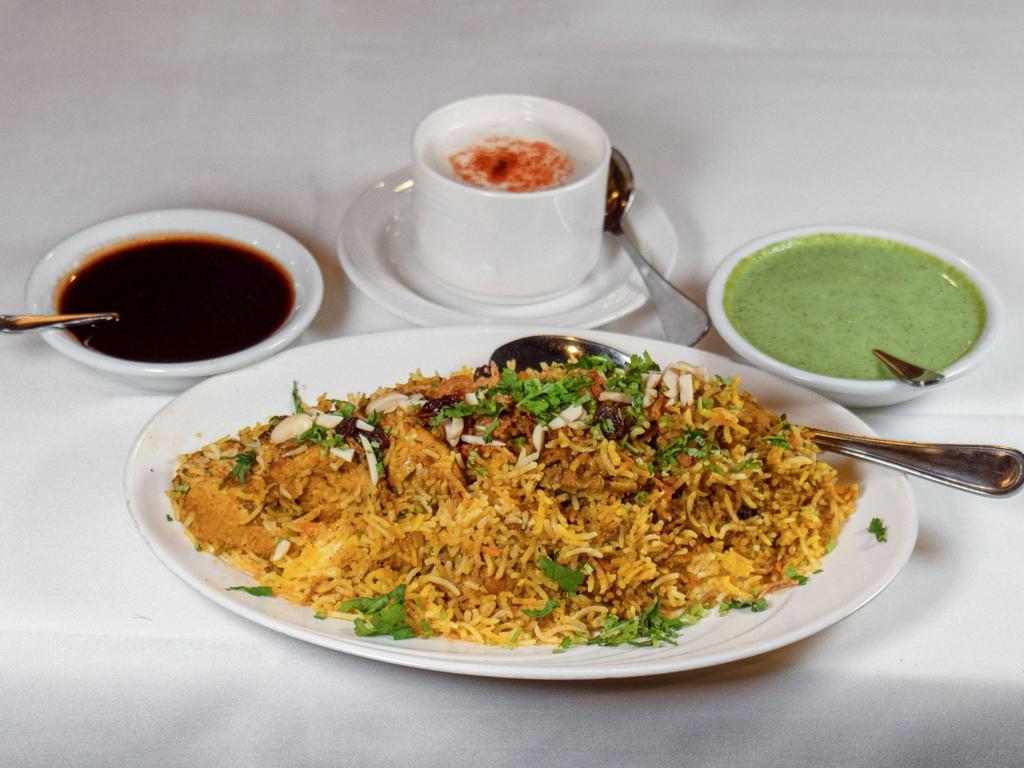 2. Murgh Biryani · Boneless chicken cooked with saffron basmati rice, marinated with herbs, spices and nuts. Served with raita. 