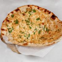 4. Garlic Naan · Leavened white flour with finely hand chopped garlic topped with poppy seeds.