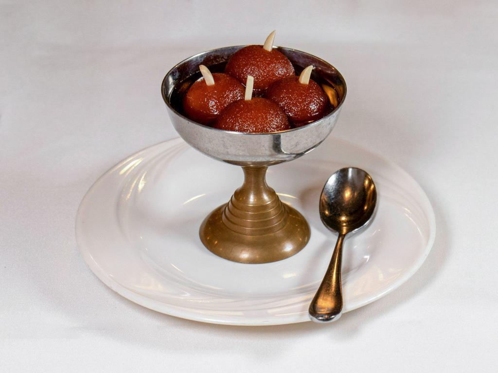 4. Gulab Jamun · Made of dry milk and soaked in syrup. Served warm.