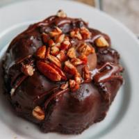 Caramel Turtle Chocolate Cake · Moist and Fudgy Chocolate Cake enrobed in Chocolate, topped with Toasted Pecans and filled w...