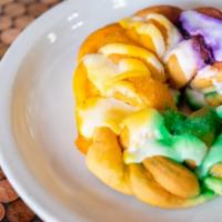 King Cake · A Cinnamon King Cake, Covered with Sugary Goodness and Topped with Gold, Green and Purple Su...
