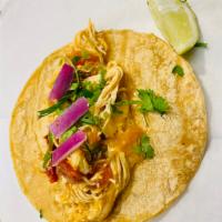 Tinga Taco · Pulled chicken, onion, cilantro, and lime.