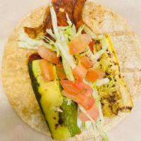 Veggie Taco · Grilled zucchini, red pepper, cheese, lettuce, and tomato.