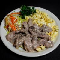 Beef Stroganoff · Tender and juicy beef steak strips smothered in a savory home made sauce Served with pasta a...