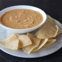 Chile con Queso · Savory melted cheese, spiced with chile peppers and Tumbleweed seasonings. Vegetarian.  Serv...