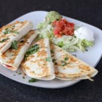 Quesadilla · Seasoned chicken, cheese, green chiles, onions and mild salsa.  Served with sour cream, pico...