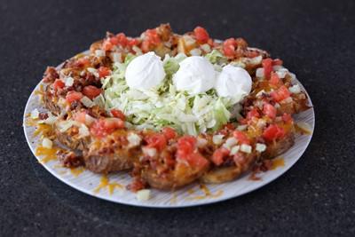 Potato Skins · Loaded with cheese, bacon, tomatoes and onions.  Served with sour cream.