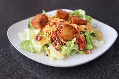 House Salad · Served with bacon, tomatoes, cheese and jalapeno croutons.