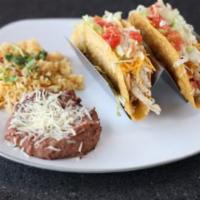 Tacos · 2 seasoned beef or chicken tacos with cheese, onion, lettuce and tomato. Served with your ch...