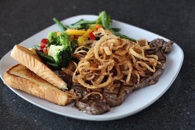 Ribeye · USDA Choice. Our house specialty! Well-marbled (where the flavor lives!), hand-cut, perfectly seasoned and topped with onion straws. Served with choice of 2 sides.