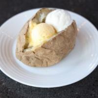 Baked Potato · Baked potato served with sour cream and butter.