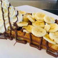 Nutella & Banana Waffle · Waffle topped with Nutella fresh banana slices and whipped cream.
