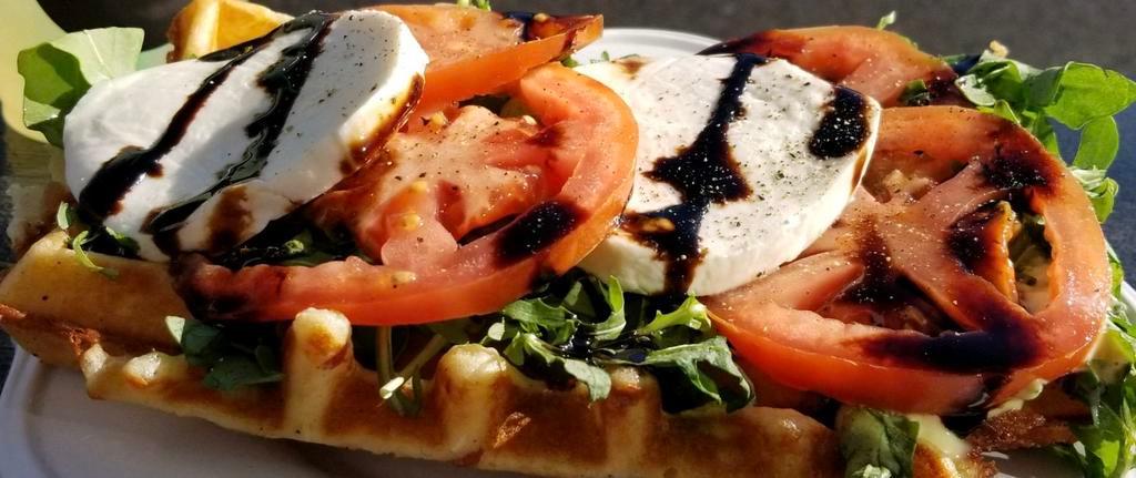 Caprese Waffle · Waffle topped with pesto aioli, fresh arugula, tomato, fresh mozzarella, and balsamic drizzle. Add bacon for an additional charge.