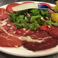 Bresaola appetizer · Italian bresaola, arugula, Parmigiano Reggiano and mixed mushrooms with extra virgin olive o...