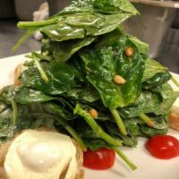 Goat Cheese and Spinach Salad · Warm goat cheese, baby spinach, honey and roasted pine nuts.