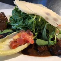 Arugula E Filetto Salad · Baby arugula salad with cubes of seared filet mignon served with marinated tomatoes and shav...