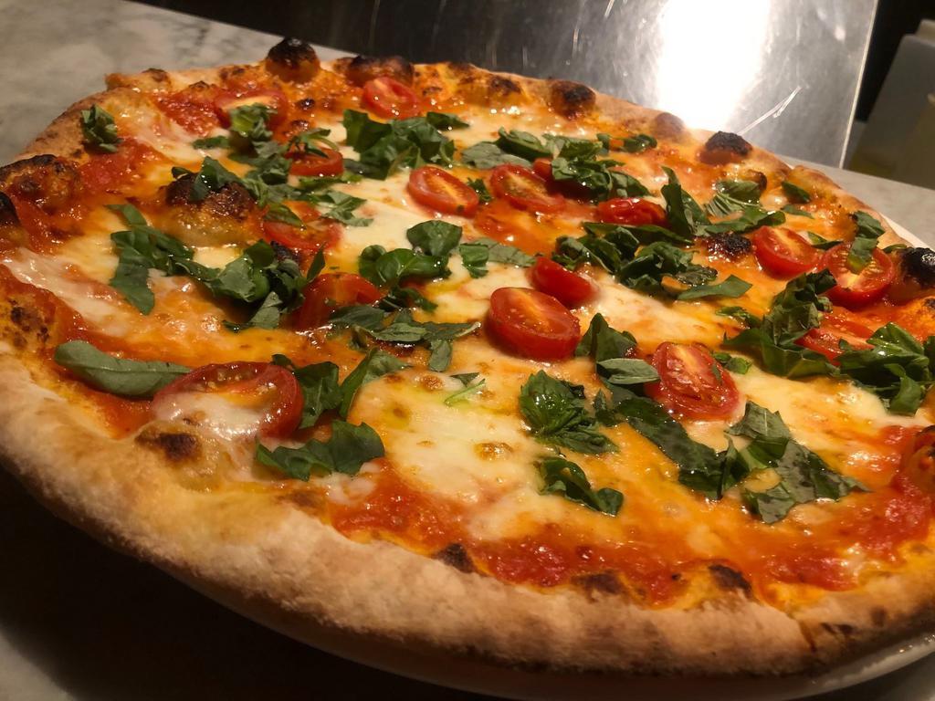 D.O.C. Margherita Pizza · Tomato, mozzarella, Parmigiano Reggiano and cherry tomatoes.