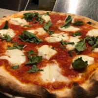 Regina Margherita Pizza · Buffalo mozzarella, tomato, cherry tomatoes and fresh basil.