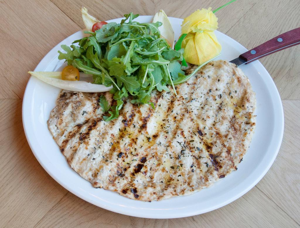 Chicken Breast Paillard · Natural free-range grilled chicken breast served with arugula and tomatoes.