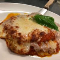 CHICKEN PARMIGIANA · Organic chicken, fresh mozzarella and home made tomato sauce, served with a side of spaghett...