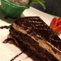 The Chocolate Sensation · 7 chocolate layers with hazelnut cream & hazelnut crunch, served with fresh whipped cream 