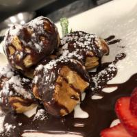 Profiteroles · Cream Puff filled with chantilly cream , covered in dark chocolate