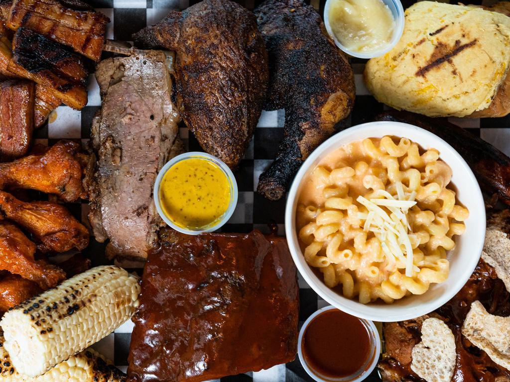 Meat Board · 1/4 lb of pulled pork, 1/4 lb of brisket, 6 oz of crispy pork belly, sliced Andouille sausage, Hot Honey Glaze 1/2 chicken, blackened ahi tuna, 1/4 Rack of Ribs. Comes with cheddar biscuits and choice of 2 sides.