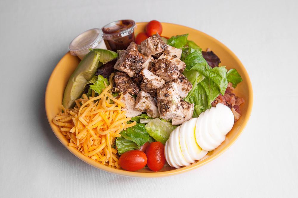 Jerk Chicken Cobb Salad · Mixed lettuce, hardboiled egg, tomato, bacon, avocado, and Cheddar cheese with ranch dressing. 
