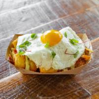 Crisp Tots and Local Egg · Herb goat cheese, smoked cheddar, avocado crema, chile butter, peppered bacon and micro gree...
