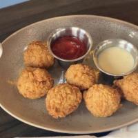 Hash Holes  · 5 hashbrown croquettes made with cheddar smoked Gouda and bacon. Served with Southwest ranch...