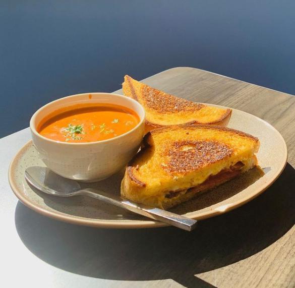 Grilled Cheese Sandies · Cheddar, Jack, and Gouda cheeses with sliced tomatoes on grilled sourdough bread. Served with tomato bisque. Add bacon or ham for an additional charges. 